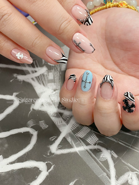 Decorative manicure with various nail art designs on extended nails.